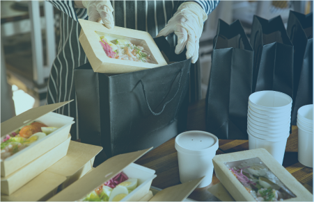 Chef packaging high end food for delivery